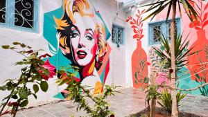 a mural of a woman on the side of a building at Wanasa House in Dahab