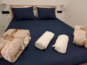 a blue bed with towels and pillows on it at Lake View Terrace Apartment Dapcevic in Vranjina