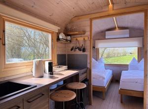 a kitchen and living room in a tiny house at Gut Osterhausen in Butjadingen