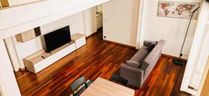 a living room with a couch and a television at MS Piazza del Papa Sea Port in Ancona