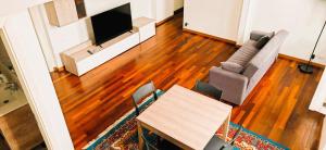 a living room with a couch and a table and a television at MS Piazza del Papa Sea Port in Ancona