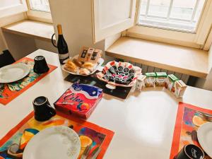 a table with plates and a bottle of wine and food at MS Piazza del Papa Sea Port in Ancona