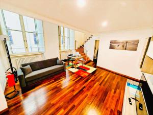 a living room with a couch and wooden floors at MS Piazza del Papa Sea Port in Ancona +12 photos