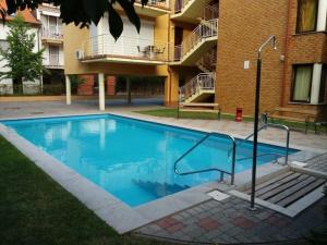 a swimming pool in front of a building at Fritz Holiday in Siófok