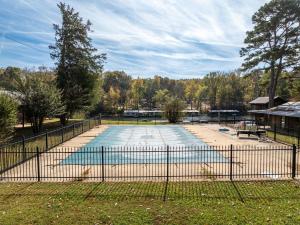 a swimming pool in a yard with a fence at Lucky Trout Lodge in Heber Springs