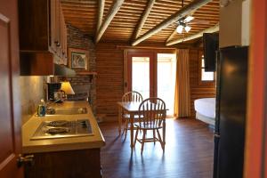 a kitchen with a sink and a table with chairs at Lucky Trout Lodge in Heber Springs