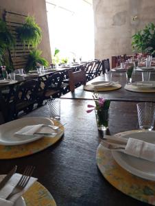 a dining room with tables with plates and utensils at Pousada Venture Jalapao in São Félix do Tocantins