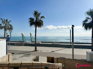 a view of a beach with palm trees and the ocean at Poble Mar 8 in Oropesa del Mar +51 photos