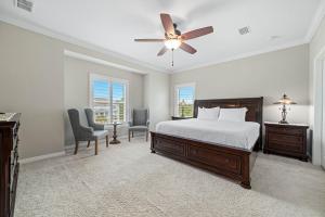 a bedroom with a bed and a ceiling fan at Salt & Pine in Pensacola
