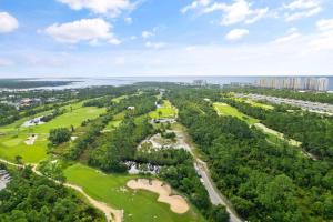 an overhead view of a golf course with trees at Salt & Pine in Pensacola