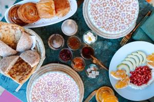 a table topped with plates of pastries and other foods at Wow Hotel Dakhla Gym, Free Jacuzzi & Breakfast Included in Dakhla