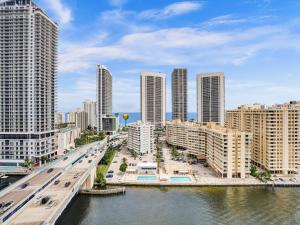 a city with a bridge over a river and buildings at Luxury 3BR Water view 18th-Floor Deck Pool in Hallandale Beach