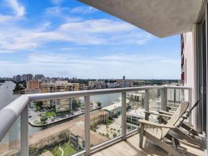 a balcony with a chair and a view of a city at Luxury 3BR Water view 18th-Floor Deck Pool in Hallandale Beach