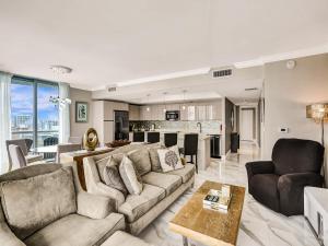 a living room with a couch and a table at Luxury 3BR Water view 18th-Floor Deck Pool in Hallandale Beach