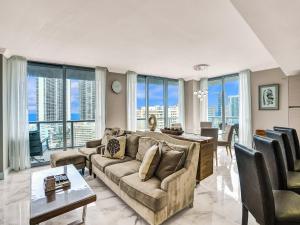 a living room with a couch and a table at Luxury 3BR Water view 18th-Floor Deck Pool in Hallandale Beach