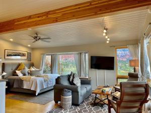 a bedroom with a bed and a tv in a room at Perfect Couples Getaway Private Hot Tub Panoramic Red Rock Views in Sedona