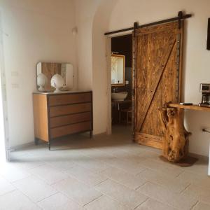 a room with a wooden door and a dresser at Masseria Petra in Martano +222 photos