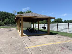 a gazebo with a picnic table in it at Relax Inn Bryan College Station in Bryan
