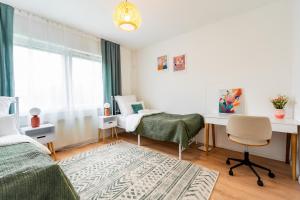 a bedroom with a bed and a desk and a chair at Wohnung in Essen in Essen