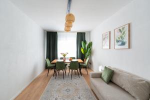 a living room with a couch and a table and chairs at Wohnung in Essen in Essen