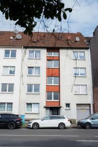 a white car parked in front of a building at Wohnung in Essen in Essen +12 photos