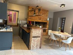 a kitchen with a counter and a table in it at GÎte à la ferme in Lalinde