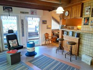 a living room with chairs and a bar in a house at Haus Schluchseeblick in Schluchsee