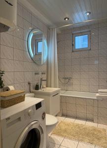 a bathroom with a washing machine in a bathroom at Perla Sea View in Budva +21 photos