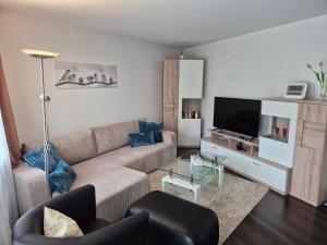 a living room with a couch and a tv at Ruhiges Nest in Bad Endorf