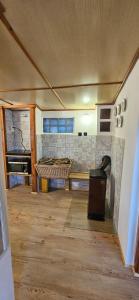 a room with a stove and a bench in a room at Chata u Hřiště in Loučeň