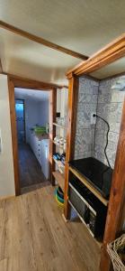 a room with a kitchen and a living room at Chata u Hřiště in Loučeň +37 photos