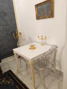 a white table and two chairs in a room at Baroque Palace Black Diamond in Arad +23 photos