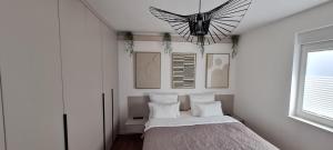 a bedroom with a bed with white walls and a window at Vila VivaVir with 2x E-Scooter, private Pool & Grill in Vir +63 photos