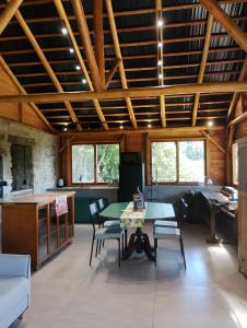 a large living room with a table and chairs at Morada da Mata in Candelária