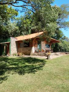 a small stone house with a grass yard at Morada da Mata in Candelária +46 photos
