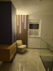 a living room with a chair and a window at Vila VivaVir with 2x E-Scooter, private Pool & Grill in Vir