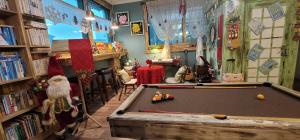 a room with a pool table in a library at Jarasum Guest House in Gapyeong