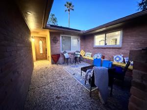 a patio with a couch and chairs on a house at Cozy Room with a Pool in Houston