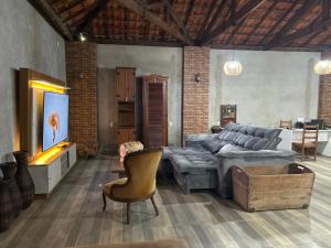a living room with a couch and a table at Hotel Ciconha in São Lourenço +58 photos