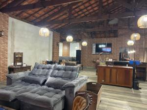 a large living room with a couch and a television at Hotel Ciconha in São Lourenço