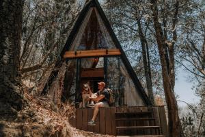 a man and his dog in a tree house at WANDER CABIN La Marquesa in La Marquesa +3 photos