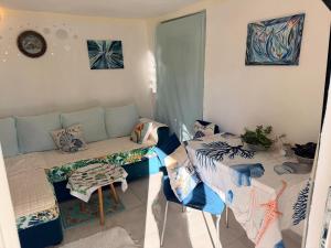 a living room with a couch and a table at Laniakea small apartment in the house in Risan in Risan