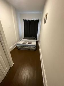 a small bedroom with a bed in the corner of a room at TORONTO UNIVERSITY PRIVATE ROOM-Next to Eaton Centre in Toronto