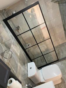 a bathroom with a toilet and a mirror at MARTIAN LANDSCAPE lUXURY CAMP in Wadi Rum +97 photos
