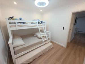 a bedroom with two bunk beds in a room at Serenity Valley Brooklyn in Brooklyn