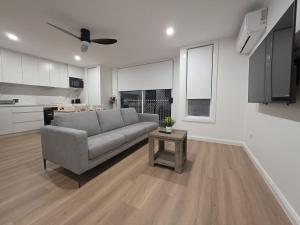 a living room with a couch and a table at Serenity Valley Brooklyn in Brooklyn