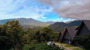 a house on a hill with mountains in the background at Coffee Cabins - Cabin 4 in Boquete