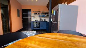a kitchen with a wooden table and a refrigerator at Coffee Cabins - Cabin 4 in Boquete +19 photos