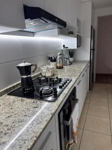 a kitchen with a stove with a pot on it at Apartment in Lima JM in Lima +2 photos