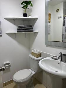 a white bathroom with a toilet and a sink at Apartment in Lima JM in Lima